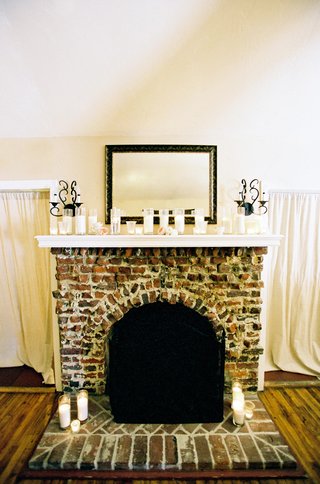 Fireplace Mantle Decorated with Candles brick-fireplace-with-a-row-of-candles-on-mantle
