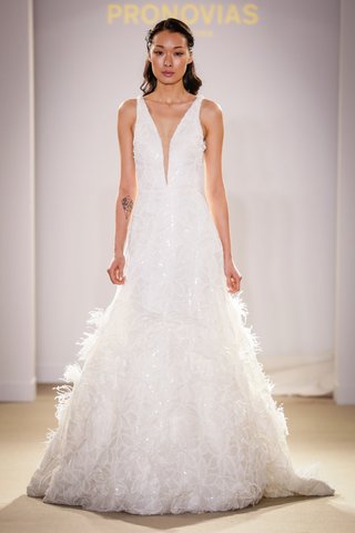 Plunging Neckline Gown by Pronovias atelier-pronovias-2019-bridal-collection-wedding-dresses-plunging-neck-a-line-feathers