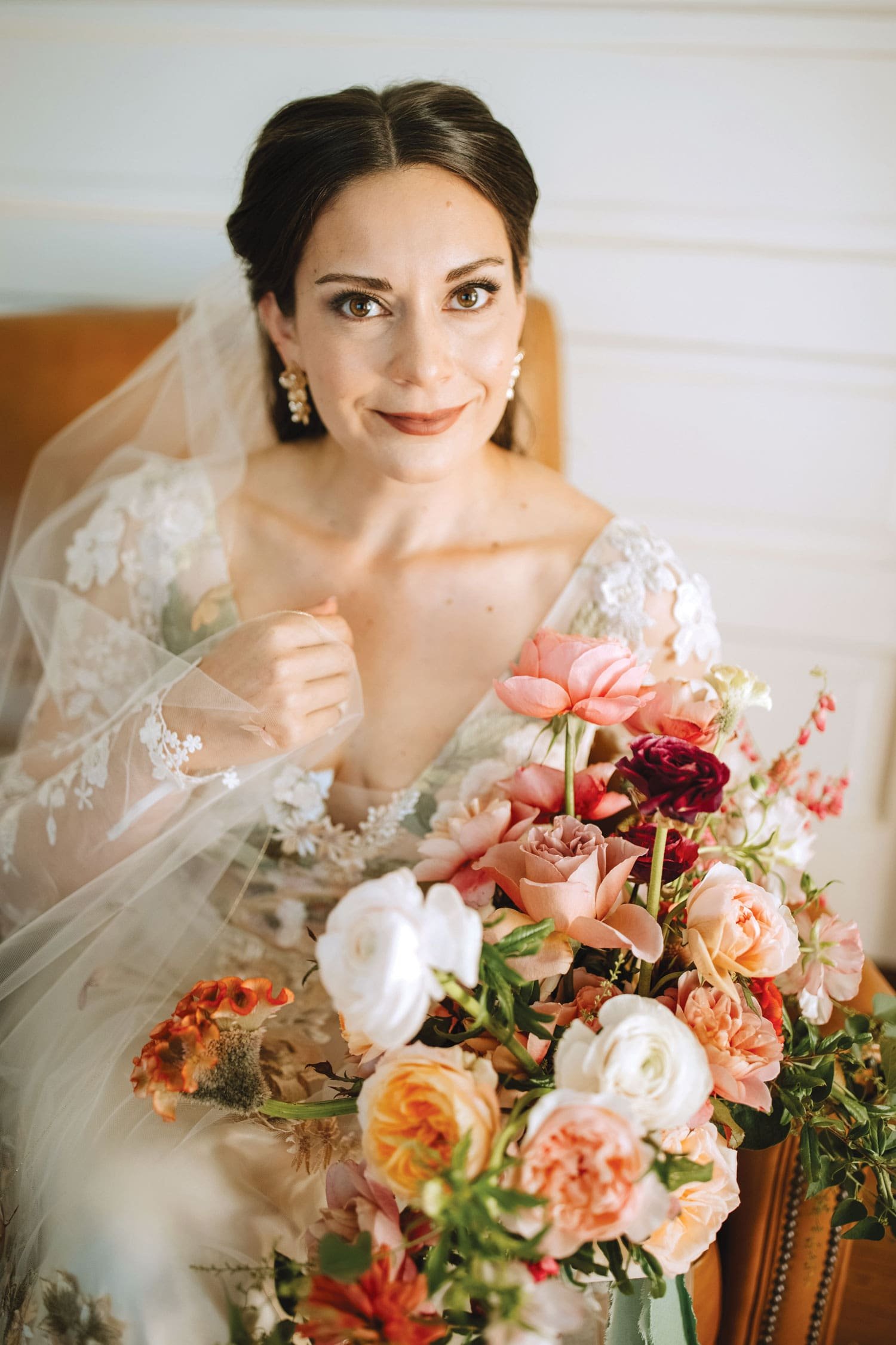 bride in claire pettibone wedding dress holding fall bouquet autumn wedding colors