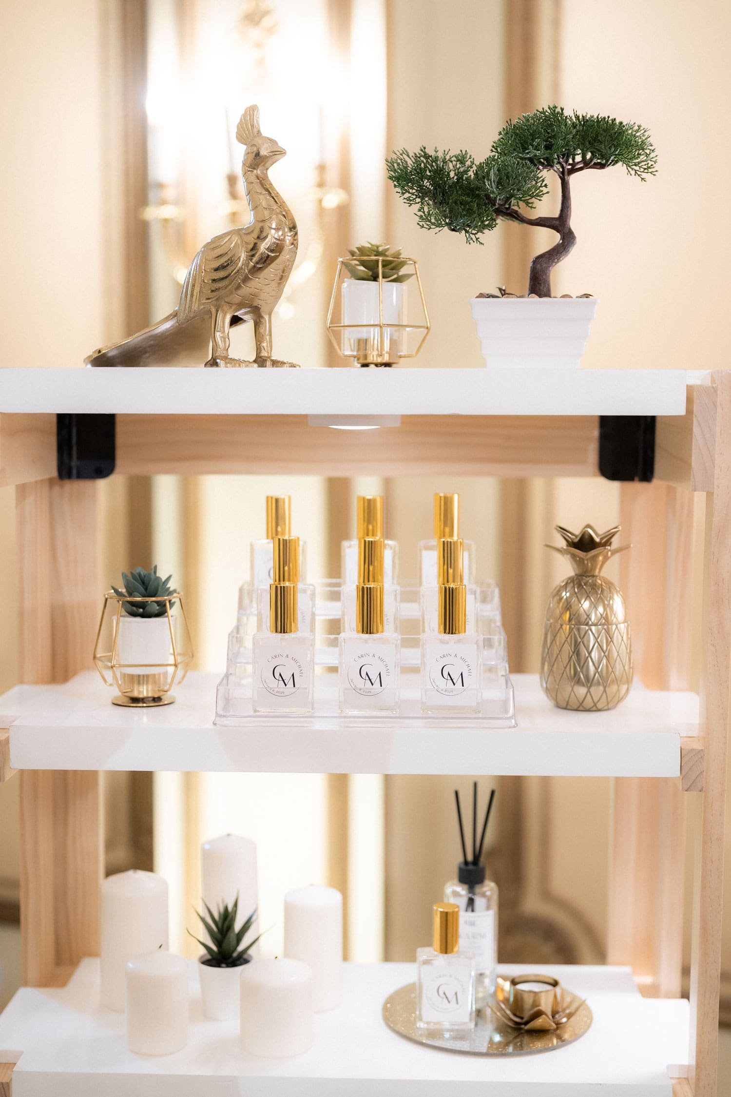 Gold and white perfume fragrance bar shelves at white and gold wedding