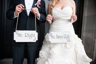 Cute Couple Portrait bride-and-groom-holding-personalized-wood-signs