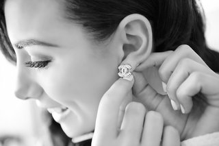 Bride Putting on Chanel Earrings