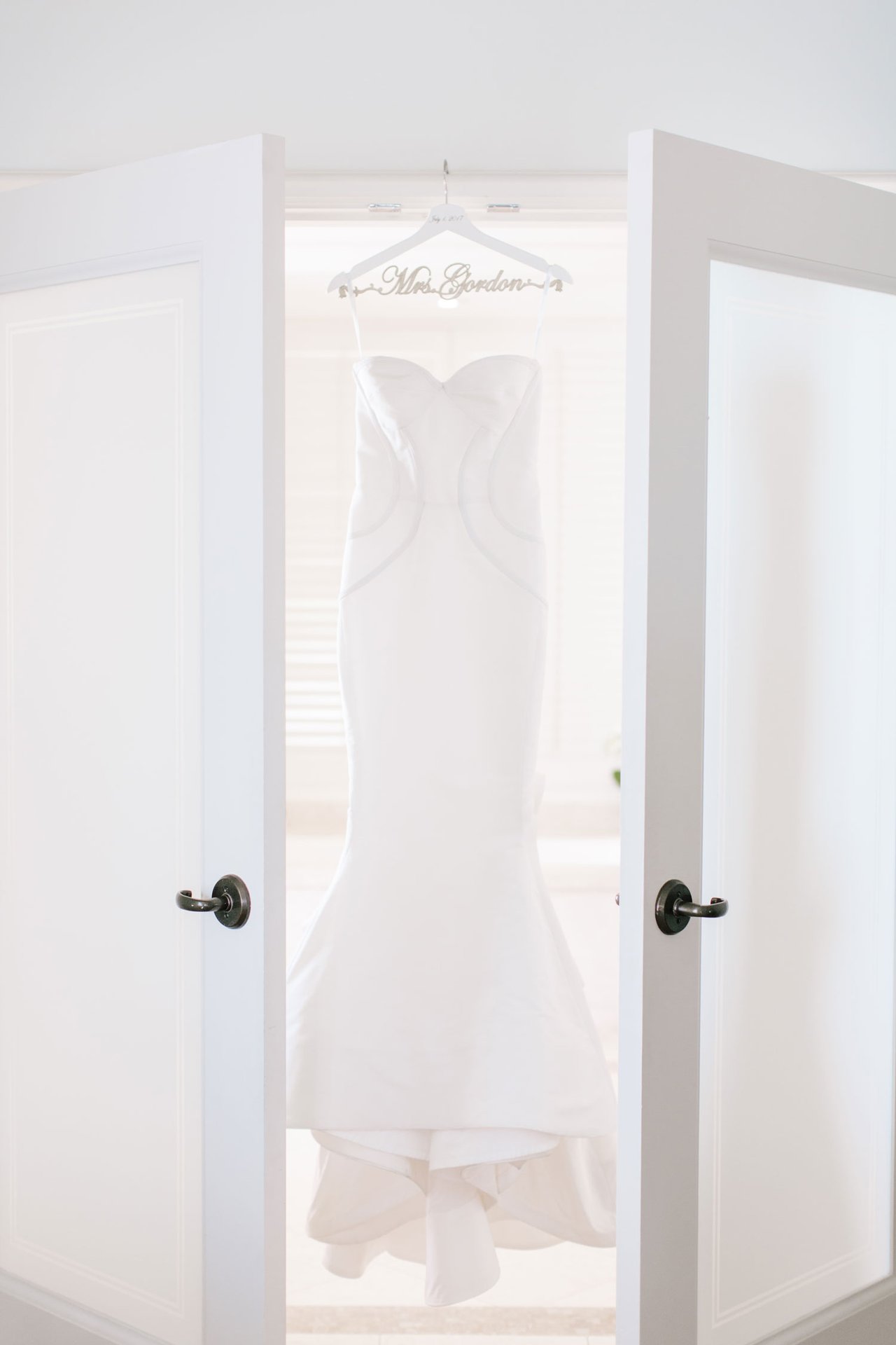 Wedding Dress Hanging in French Doors