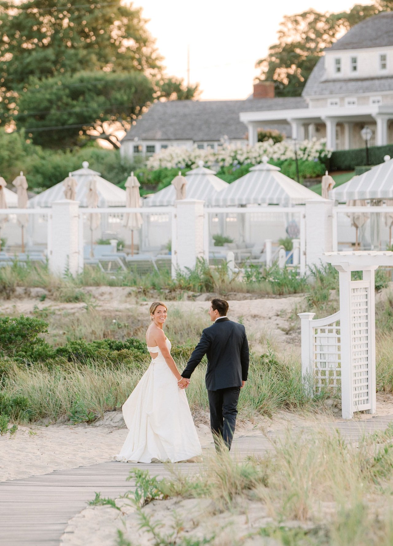 Bride & Groom Walking Toward Cape Cod Wedding Venue