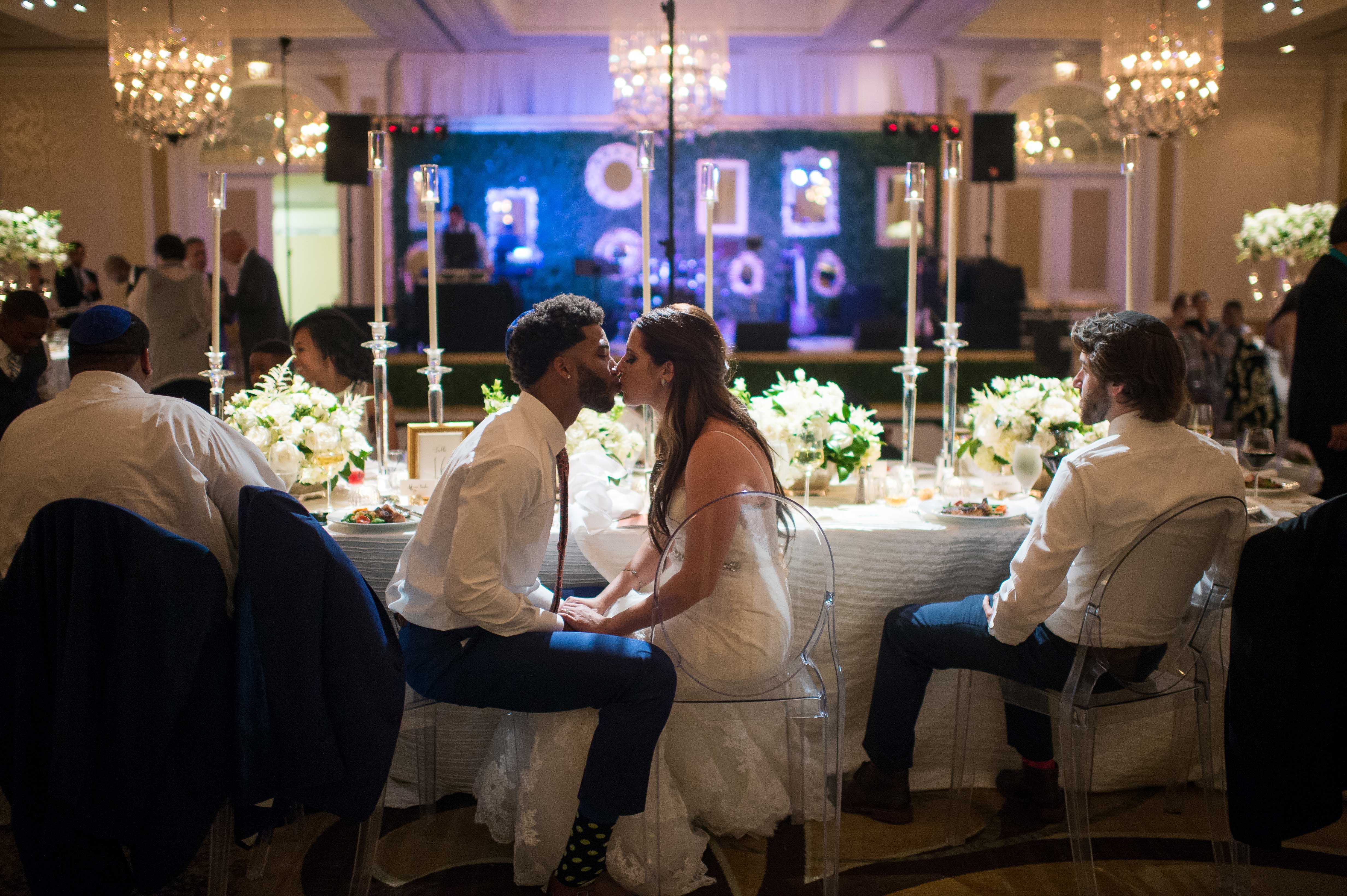 Newlywed Couple Kisses at Reception