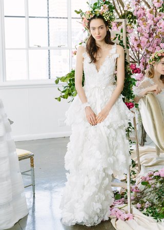 Layered Gown with V-Neckline by Marchesa Notte Bridal. marchesa-notte-bridal-spring-summer-2018-gown-deep-v-neck-ribbon-belt-tiered-skirt-floral-appliques