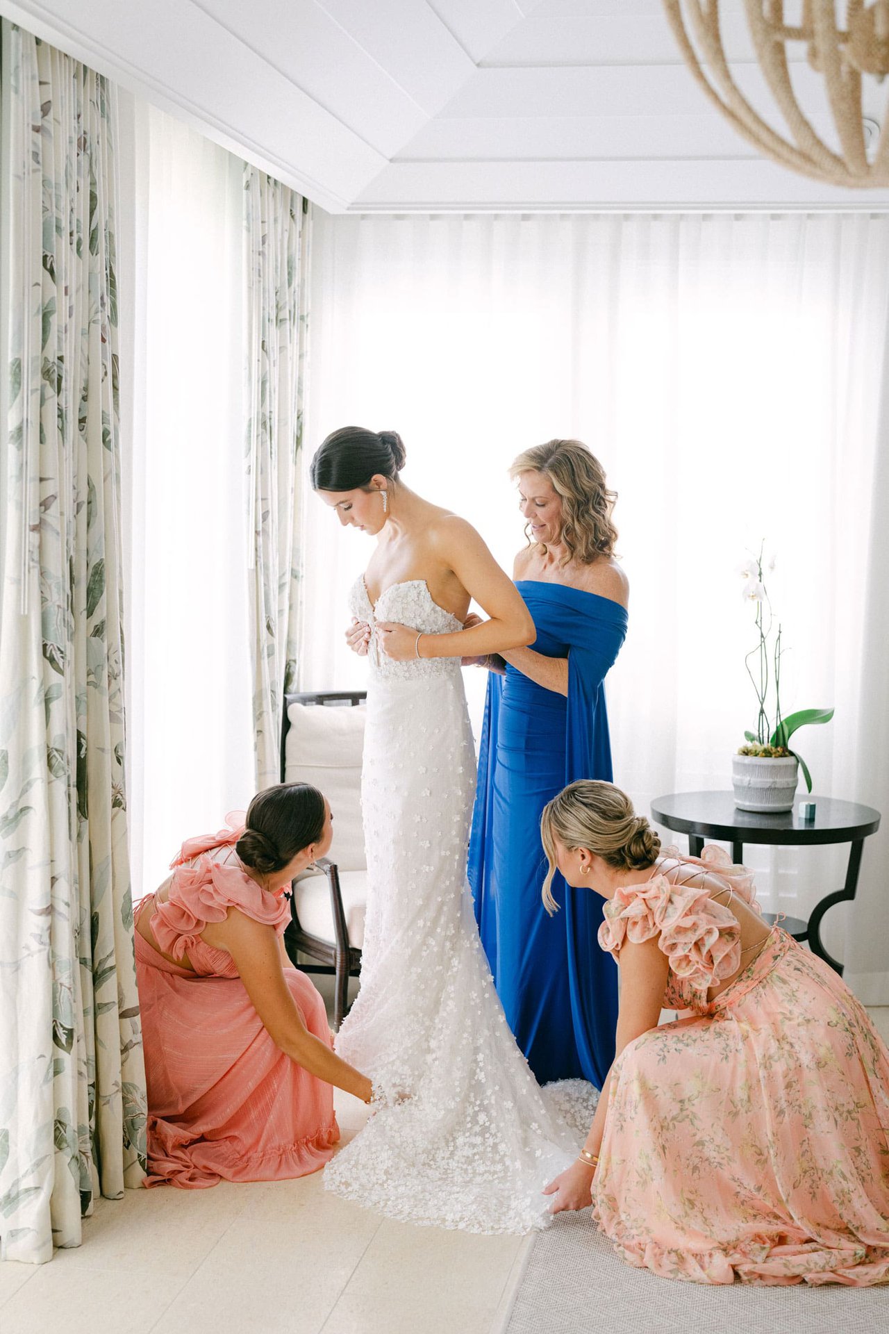 Bride Getting Helped Into Wedding Dress