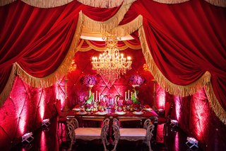Theater Curtains Frame Table Setting beauty-and-the-beast-inspired-table-setting-framed-by-red-theater-curtains