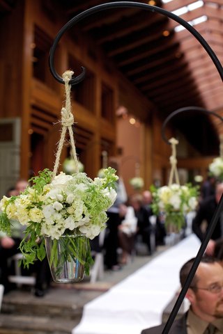 Rustic Aisle Decorations shepherd-hook-holding-white-flowers-hanging-from-rope