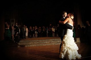 First Dance Kiss bride-and-groom-kiss-on-wood-dance-floor-at-reception