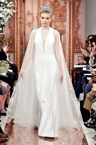 "Frederica" by THEIA frederica-by-theia-spring-2019-ivory-crepe-fitted-halter-gown-with-beading-worn-under-cape