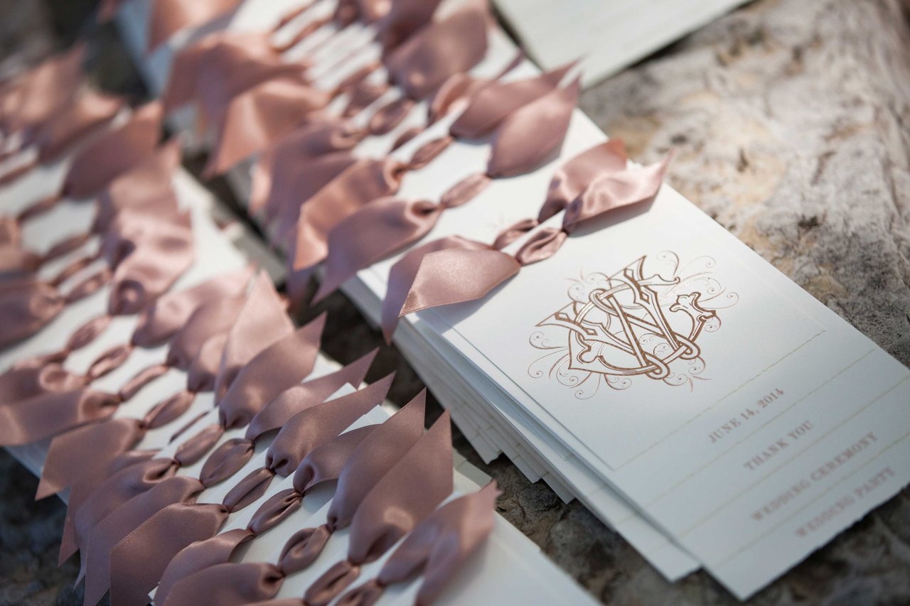 White Programs with Pink Bows at Top