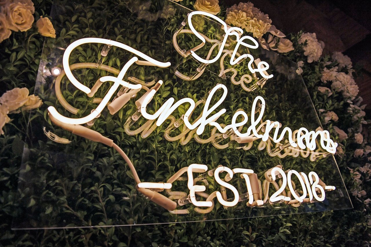 Custom Neon Sign on Hedge Wall