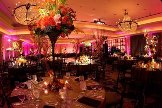 Vibrant Ballroom Wedding pink-lighting-in-reception-ballroom-with-large-flower-centerpieces