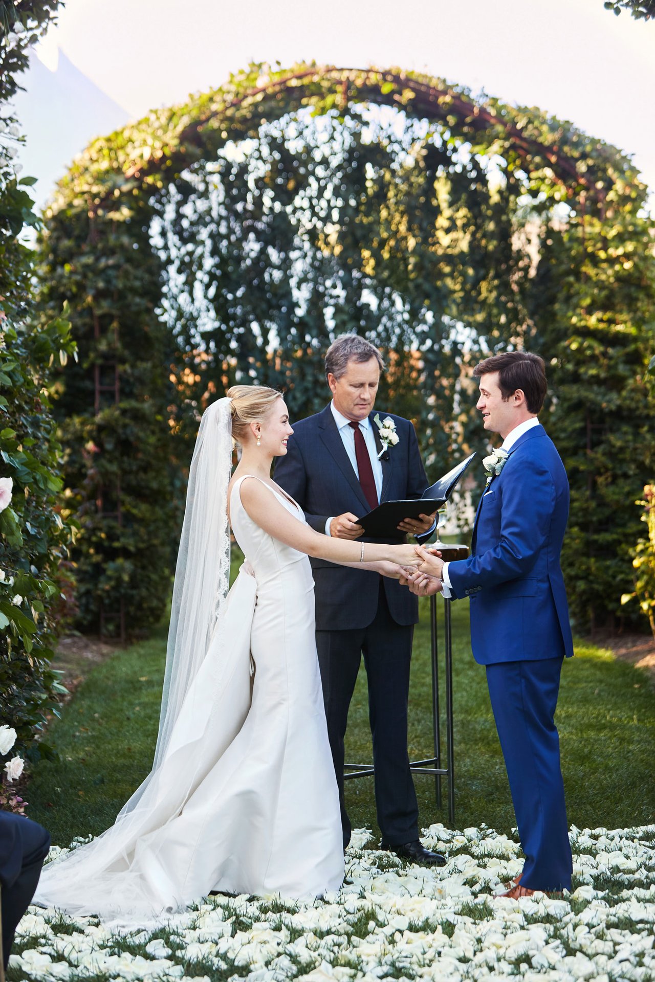 Bride & Groom Under Arch with Officiant