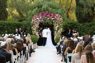 Jewish Ceremony with Pink & Green Chuppah wedding-ceremony-at-the-beverly-hills-hotel-groom-in-white-jacket-pink-white-green-wedding-arch