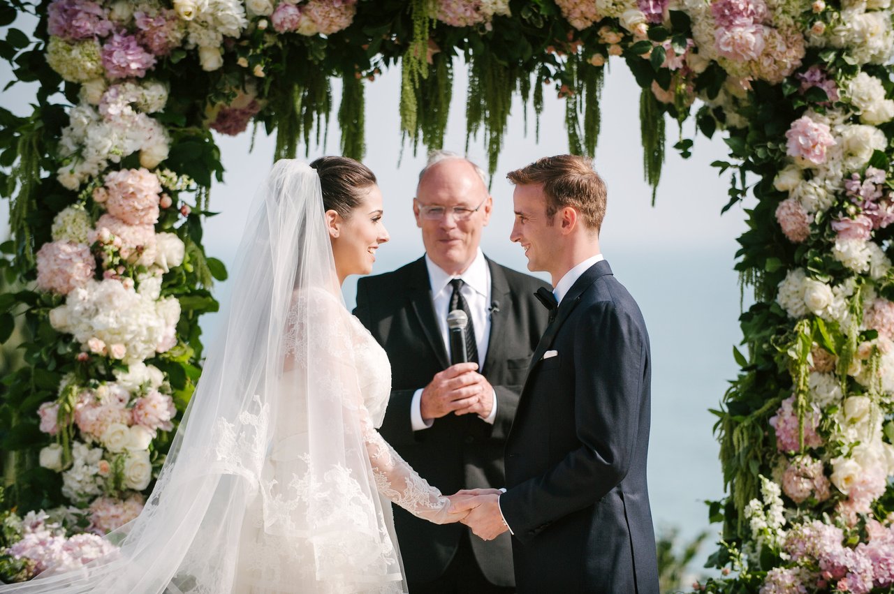 Bride and Groom Exchange Vows Under Arch