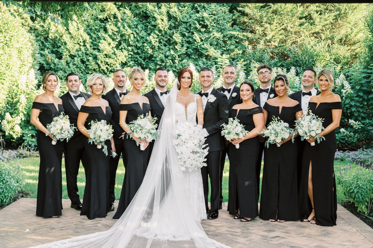 black bridesmaid dresses and black groomsmen suits Birdy Grey Suits | Nothing beats the timeless look of a classic black tuxedo and black bridesmaid dresses from @birdygrey Bride: @averyydiedrich Venue: