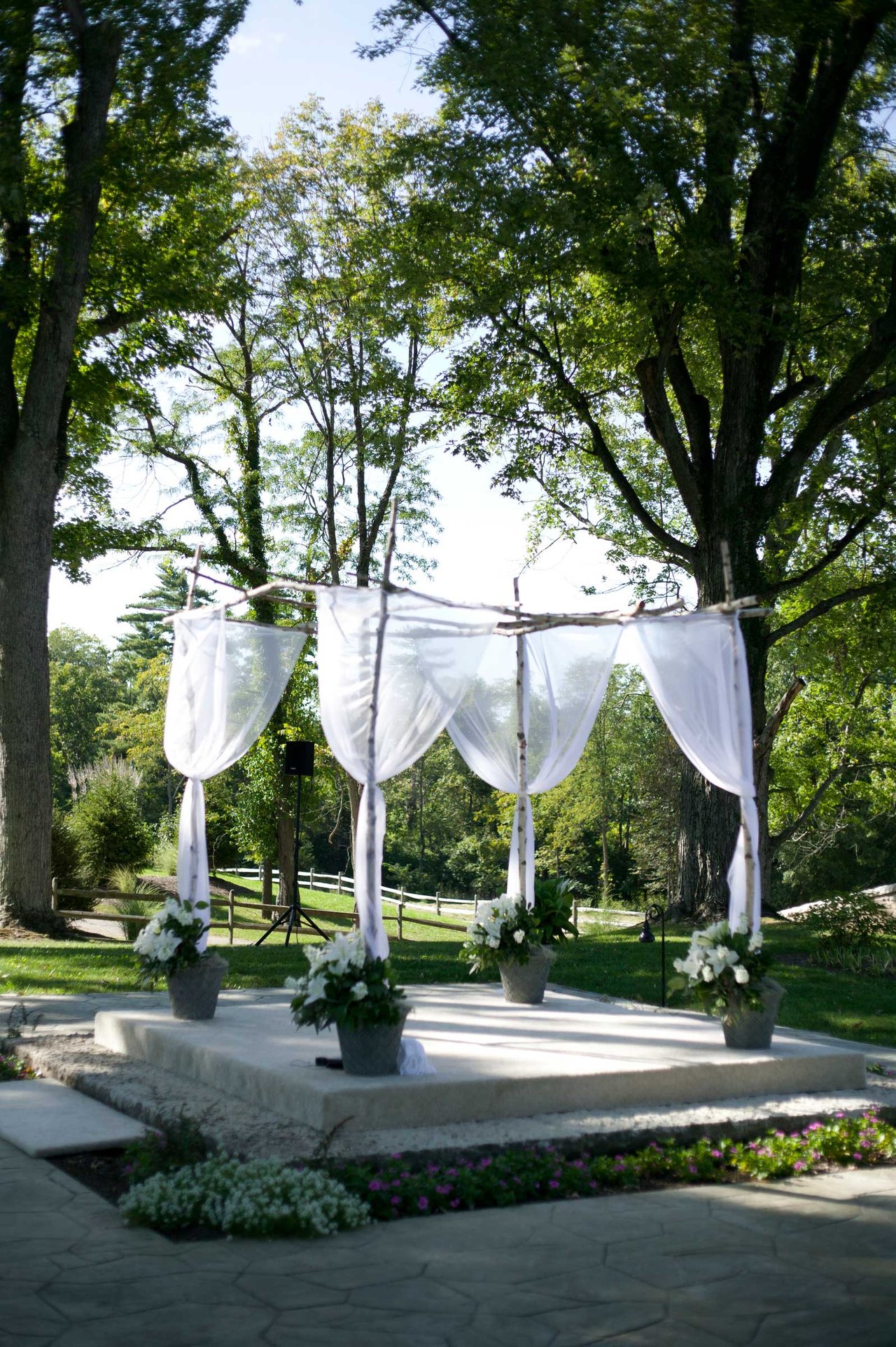 Chuppah with White Fabric at Outdoor Ceremony