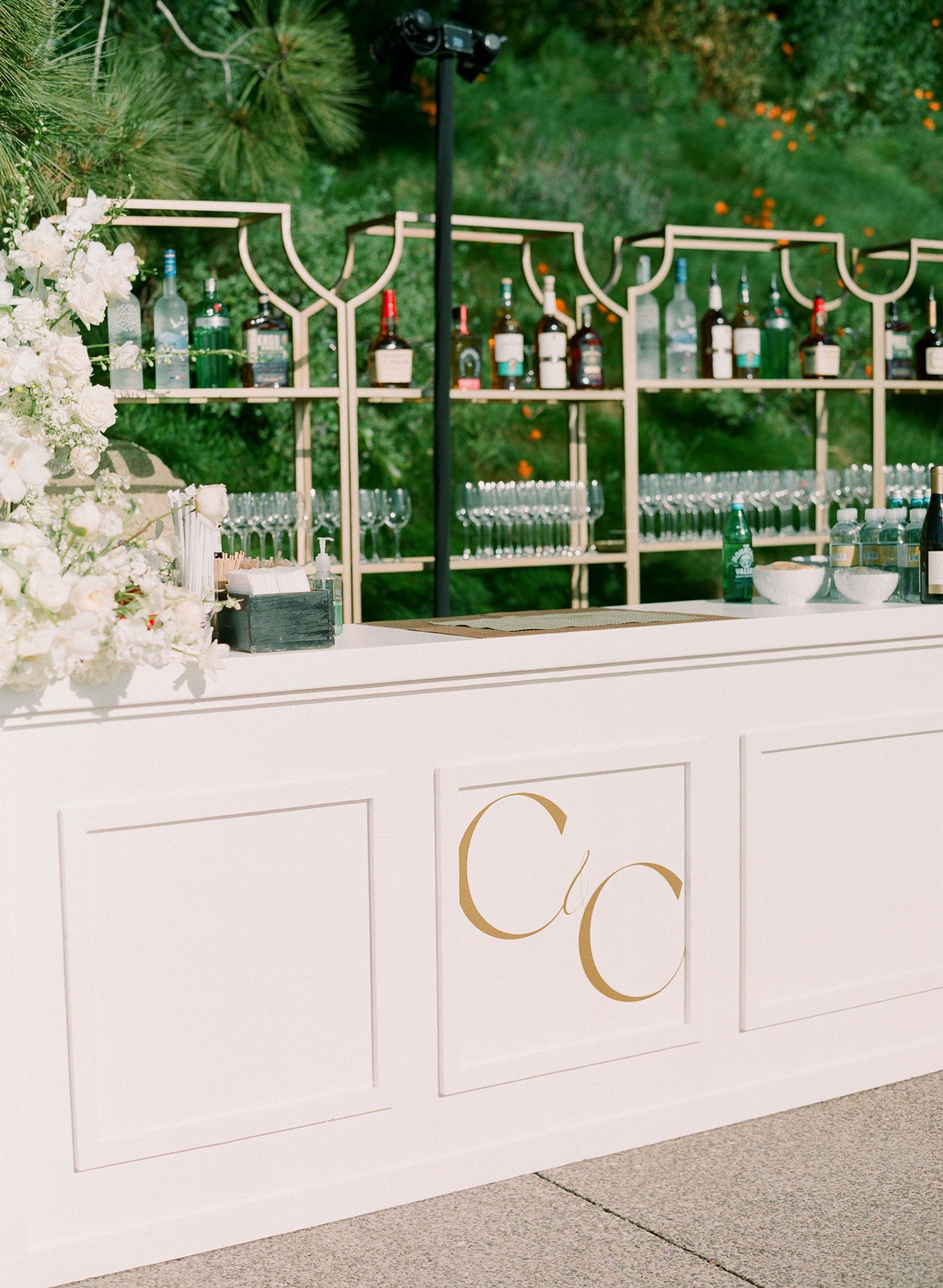 Gold and white monogram at cocktail hour bar for white and gold wedding