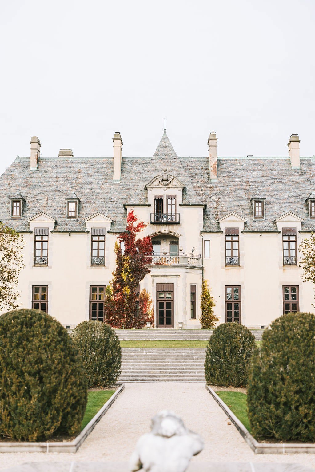 oheka castle with fall foliage on facade new york wedding venue castle