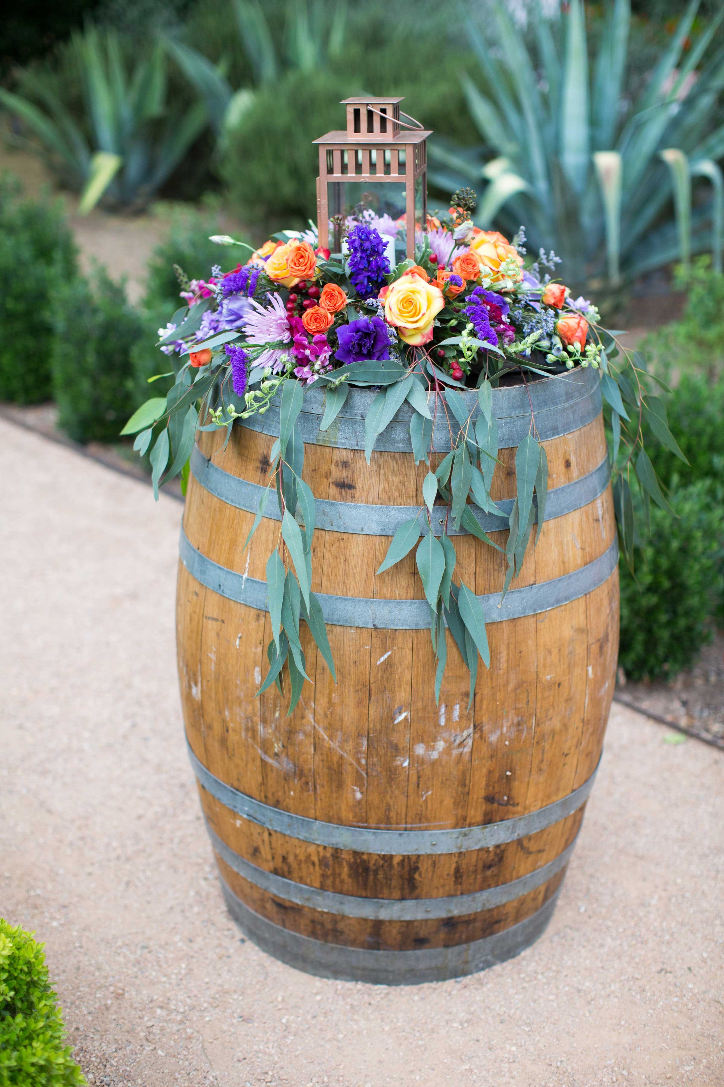A Colorful Floral Arrangement Atop a Wine Barrel