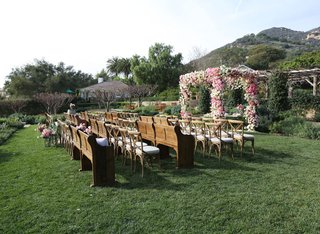 Floral Chuppah & Wooden Pews san-ysidro-ranch-outdoor-wedding-ceremony-with-pink-white-rose-chuppah-and-wood-pews-and-chairs