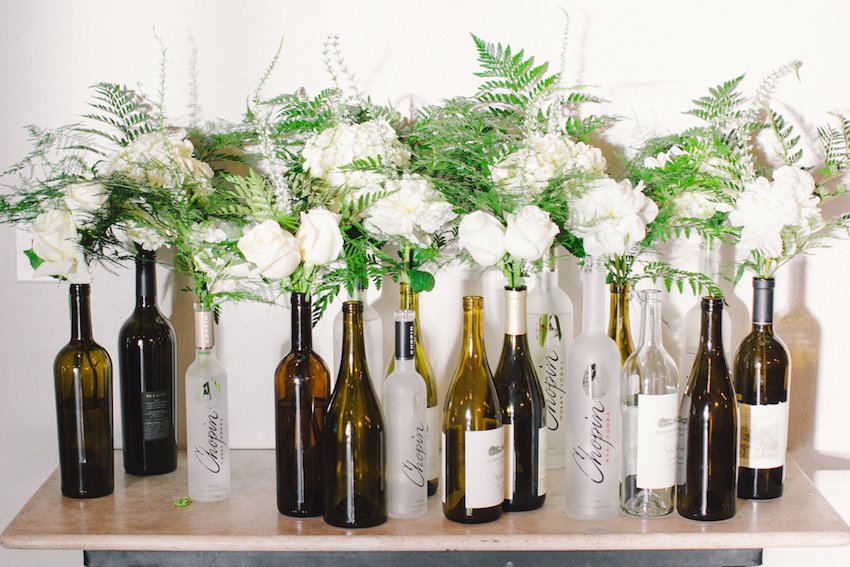 White Flowers in Wine Bottles