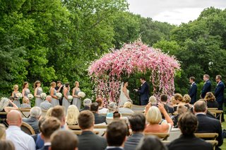 Pink & White Floral Chuppah wedding-ceremony-in-countryside-greenery-pink-and-white-little-flowers-on-ceremony-structure