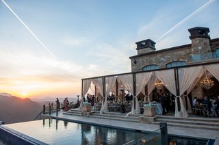 Poolside Reception Overlooking Mountains malibu-rocky-oaks-vineyard-reception-overlooking-the-mountains-with-sheer-drapery-on-terrace-pool